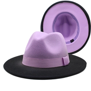 Detail of two-tone fedora hat showing purple crown, black brim and internal lining