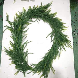 Detailed view of artificial Norfolk Pine wreath showing realistic PE pine needle textures