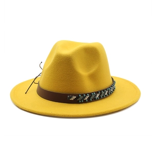 Detail of bright yellow wool fedora featuring an ethnic beaded hat band in deep brown