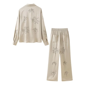 Detailed back view of champagne satin shirt and pants set with floral embroidery