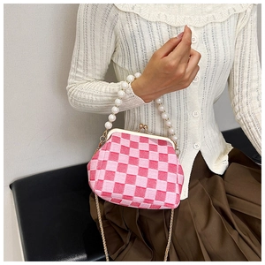 Close-up of pink and white checkered woven bag with pearl handle and metal clasp