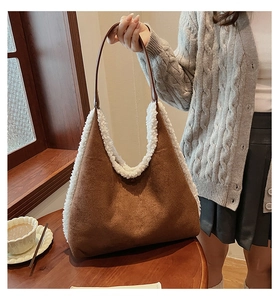 Brown faux suede and white plush patchwork tote bag shown in a cozy cafe setting