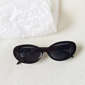 Macro shot of vintage black oval frame sunglasses with high-quality thick resin texture