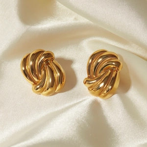 Macro view of 18k gold plated stainless steel earrings with twisted rope wave texture