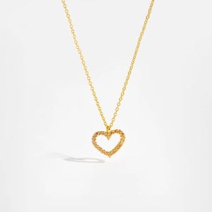 Close-up of a gold heart pendant featuring sparkling champagne pavé zircons on a link chain