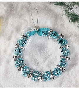 Blue and silver Christmas bell wreath detail with ribbon on white snow background