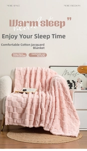 Detailed close-up of pink waffle pattern fleece blanket on a cozy white sofa