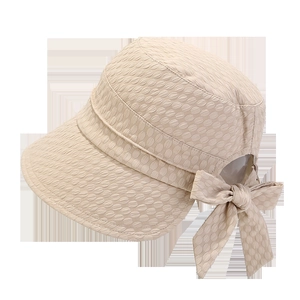 Detail of beige sun hat with bubble texture fabric and stylish rear bow tie design