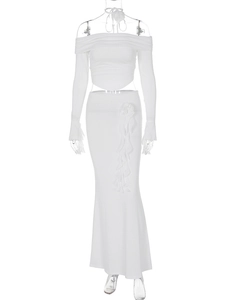 Detailed view of white two-piece set featuring off-shoulder top and floral mermaid skirt
