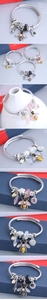 Detailed macro view of bohemian bracelet with crystal beads and bee charms on silver wire
