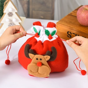 Detail of red Christmas reindeer drawstring gift bag with soft felt texture and sturdy cord