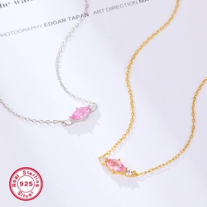 Detailed macro view of S925 silver necklaces with pink marquise zircon pendants in gold and silver