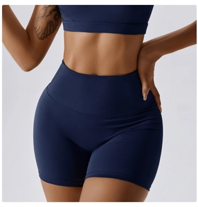 Close-up of high-waisted navy yoga shorts showing body-shaping fit and fabric detail