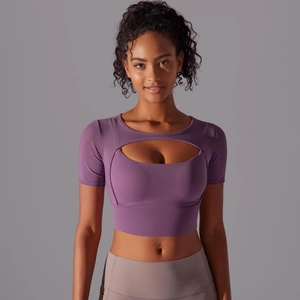Detail of purple short-sleeved fitness crop top with stylish oval chest cutout detail