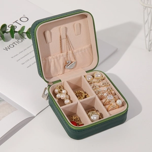 Green leather jewelry organizer with velvet interior for necklaces and rings