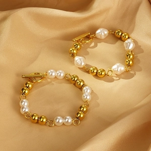 Elegant 18k gold plated stainless steel bracelet with white pearls on gold silk background