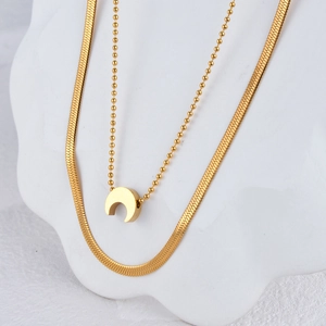 Double layered 18K gold plated stainless steel necklace featuring a crescent moon pendant