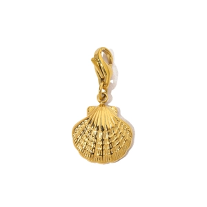 Macro detail of golden scallop shell pendant with a secure lobster clasp attachment
