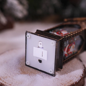 Detail of Christmas lantern base with battery compartment and power switch mechanism