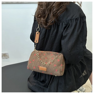 Brown corduroy cylinder crossbody bag with red strawberry print and chain strap