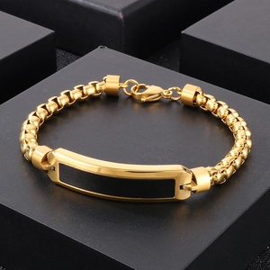 Detail of gold pearl chain bracelet for men with black bar plate and lobster clasp
