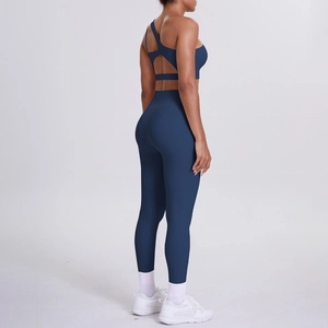 Detail of the navy blue yoga set showing the cross-strap open back bra and high-waist leggings