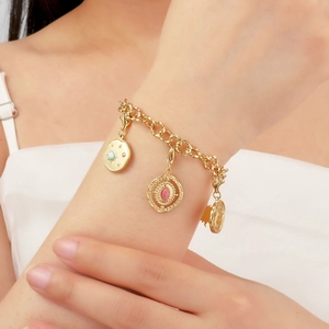 French gold titanium steel bracelet with removable stone pendants on a female model