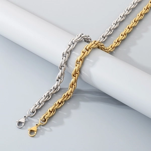 Detailed close-up of textured gold and silver twisted cuban chains with lobster clasps