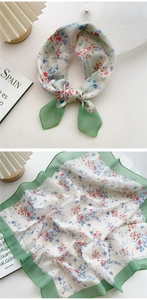 Detail of floral cotton linen neckerchief with green borders and delicate flower patterns