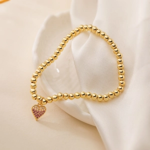 18K gold-plated beaded bracelet featuring a heart pendant set with pink cubic zirconia