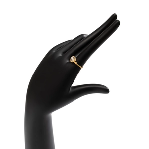 Detail of handmade wire-wrapped ring with a translucent natural gemstone on a black hand model