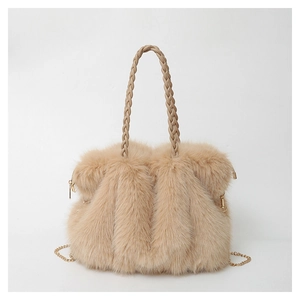 Close-up of beige plush tote bag with soft faux fur texture and woven leather handle