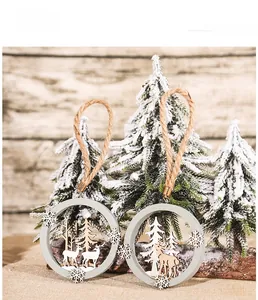 Detail of wooden Christmas ornament featuring laser-cut reindeer and forest scene