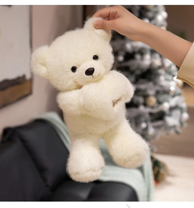 Close-up of the fluffy cream teddy bear's soft fur and cute face in a cozy home setting