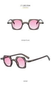 Detail of square punk sunglasses featuring grey frames and pink gradient lenses