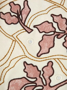Close-up of floral embroidery with mirror sequins on a vintage sleeveless vest