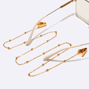 Detail of golden bead chain with crocodile clip for glasses and face mask