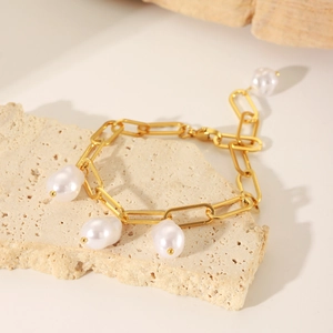 Close-up of 18K gold-plated stainless steel chain bracelet with baroque pearl pendants