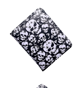 Close-up of gothic spider and skull print texture on high-quality synthetic leather wallet