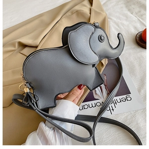 Detail of grey elephant-shaped crossbody bag with gold chain and adjustable strap