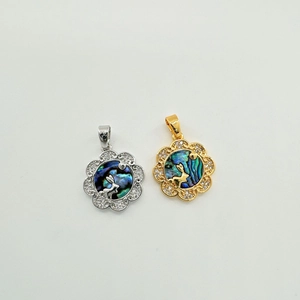 Macro shot of 18K plated rabbit flower charm with shell inlay and sparkling cubic zirconia