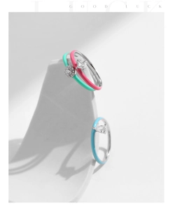 Detail of colorful enamel stackable rings with teardrop zirconia on stone blocks