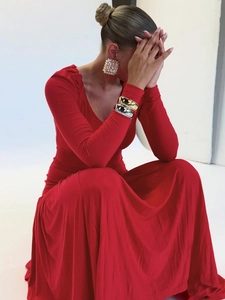 Slim fit red V-neck maxi dress with long sleeves and pleated waist details in studio