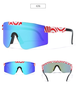 Detail view of sports sunglasses featuring blue mirrored lenses and red patterned frames