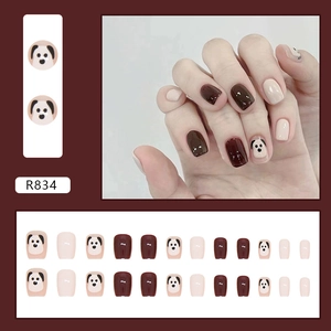 Cute puppy press-on nails with burgundy and beige patches in a short trapezoid style