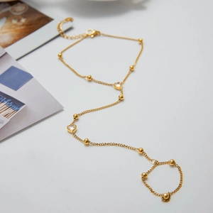 Detail of 18K gold-plated double-layer ring bracelet with heart crystal and metal beads