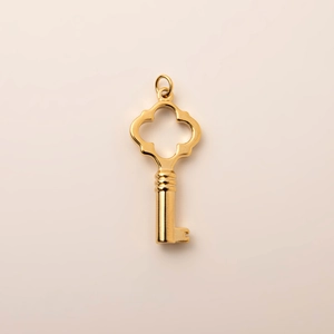 Detailed macro view of an 18K gold-plated stainless steel heart-shaped key pendant