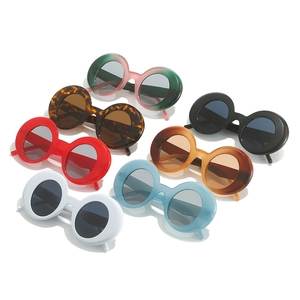 Collection of round thick-frame sunglasses in various vibrant colors on a white background