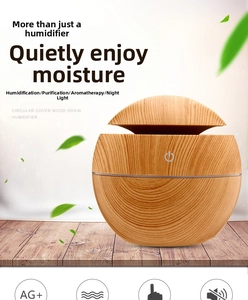 Detail view of round wood grain humidifier with touch sensor on a natural wooden table