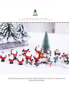 Detailed view of resin Santa and snowman figurines in a snowy Christmas scene
